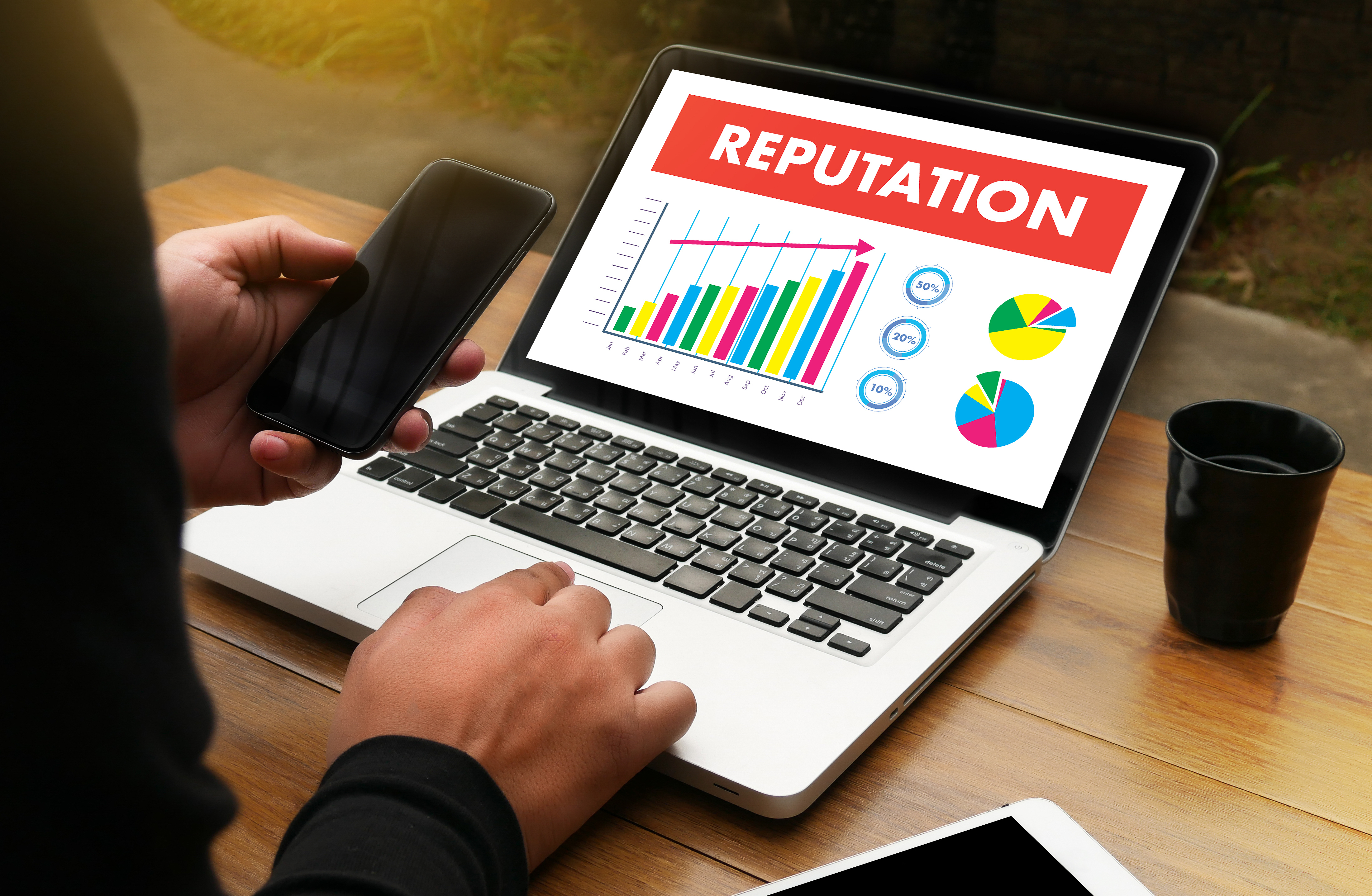 Computer with a graph on it showing an increase in reputation